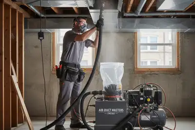 HVAC technician performing professional air duct cleaning at a Chicago, IL home for Five Star Cooling